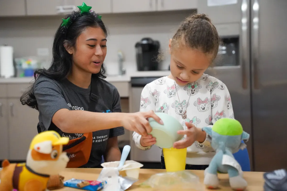 Therapist and child in play-based ABA session