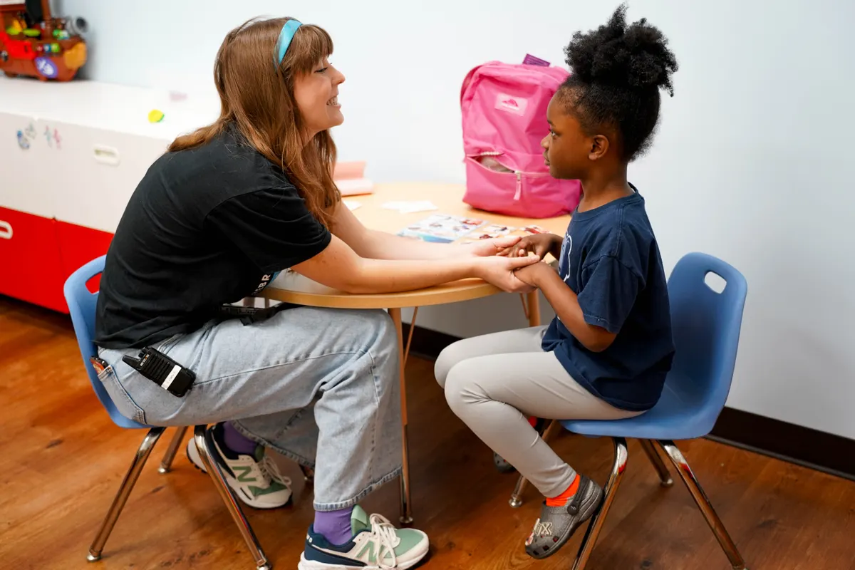Child and therapist working together at a table during an ABA therapy session