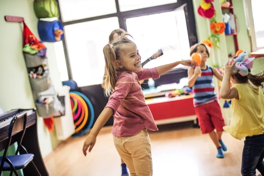 a group of children are playing with toys in a room