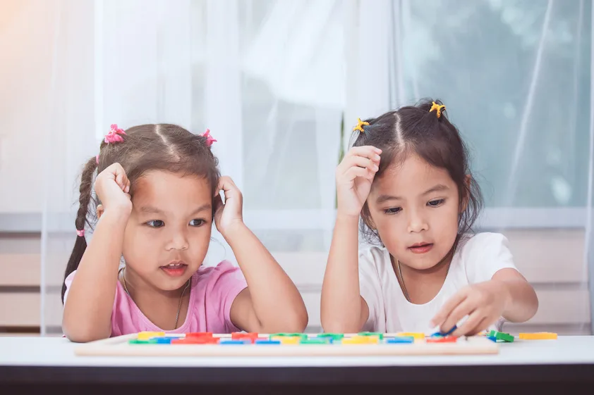 siblings playing a game at home