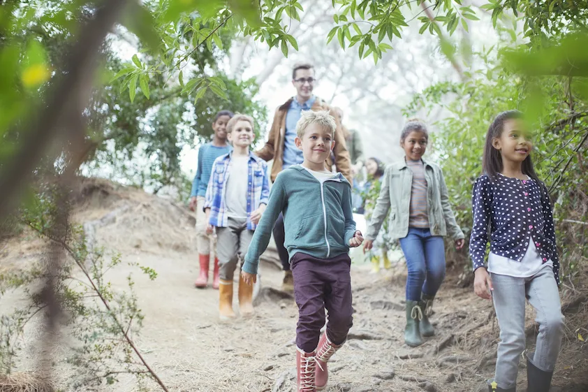 group of children hiking with a councilor