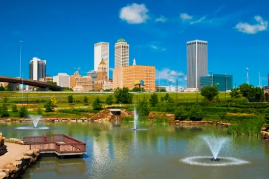 a city skyline with a fountain in the foreground