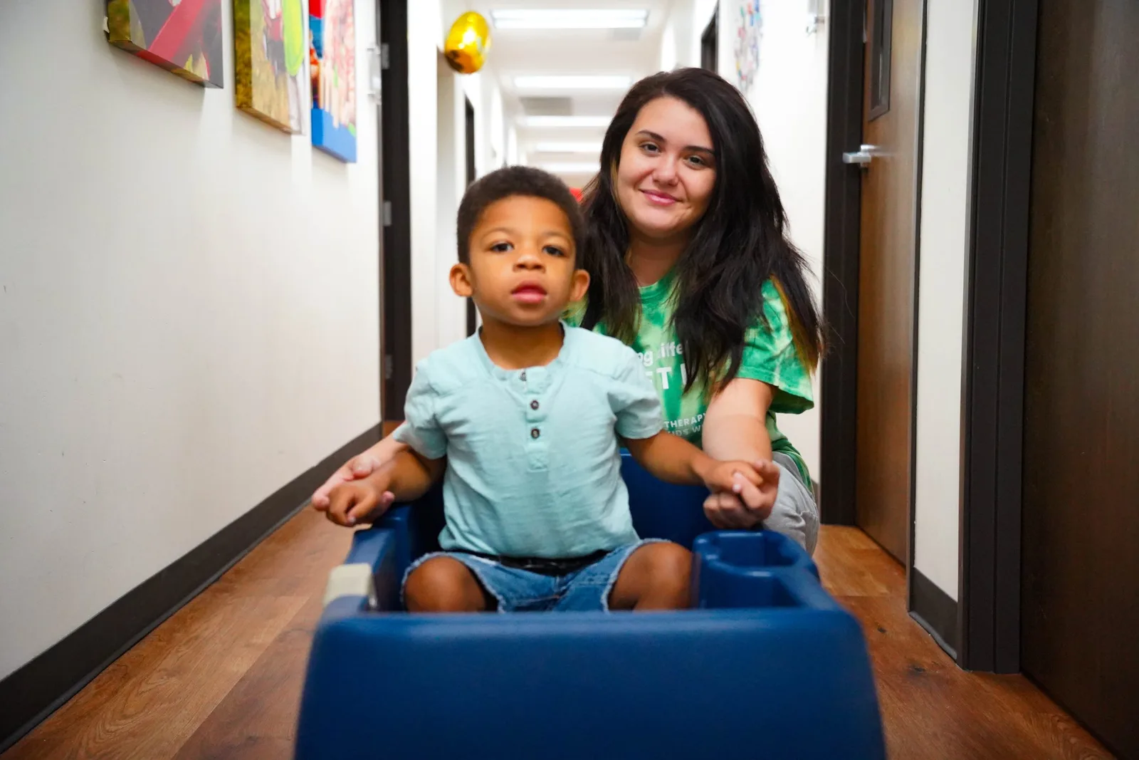 young boy riding in a cart