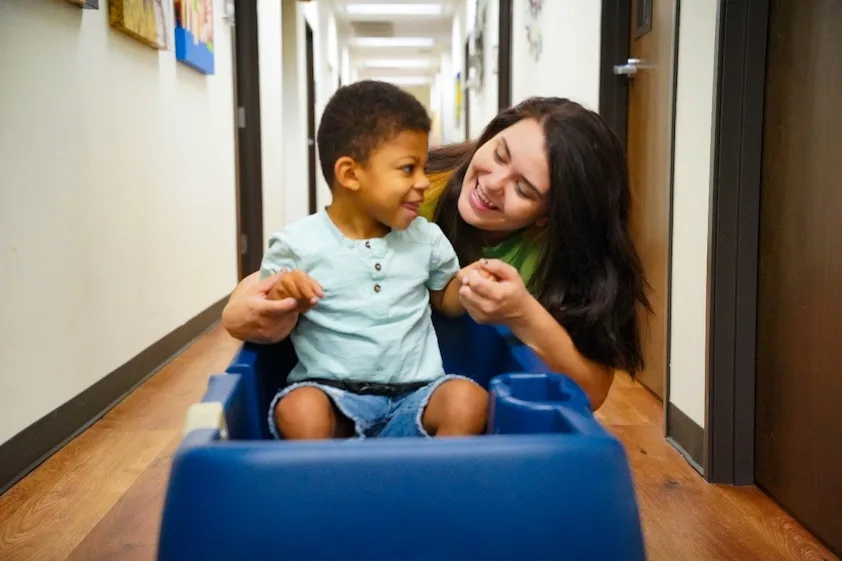 Child riding in a toy wagon