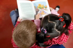 Children reading book together