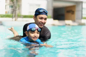 Little boy and father enjoy swimming