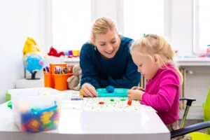 teacher playing games with young student