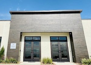 the front of a building with a lot of windows and doors