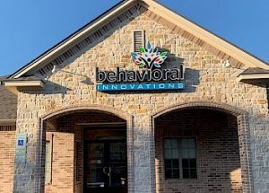 the front of a brick building with a sign that says behavioral innovations
