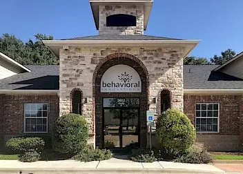 the front of a brick building with a sign that says behavioral innovations