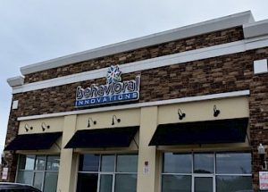 the front of a behavioral innovations building with a car parked in front of it