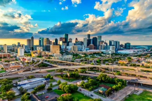 an aerial view of a city with lots of highways and buildings