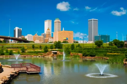 a city skyline with a fountain in the foreground