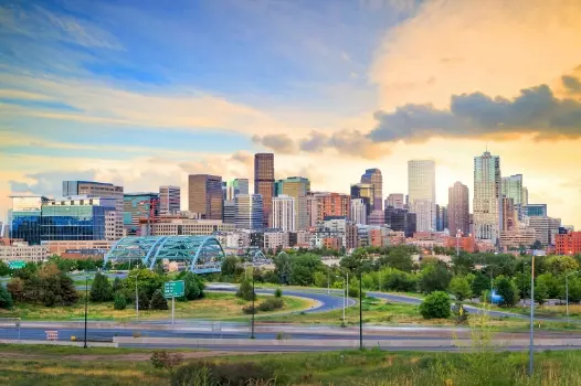 a city skyline with a bridge in the foreground