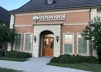 a brick building with a sign that says behavioral innovations on it