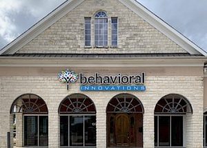 the front of a brick building with a sign that says behavioral innovations