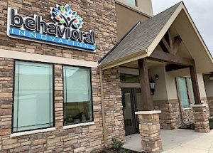 a stone building with a sign that says behavioral innovations on it