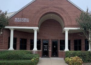 the front of a brick building with a sign that says behavioral innovations