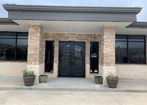 a large brick building with a black door and windows