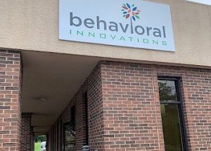 a brick building with a sign that says behavioral innovations on it