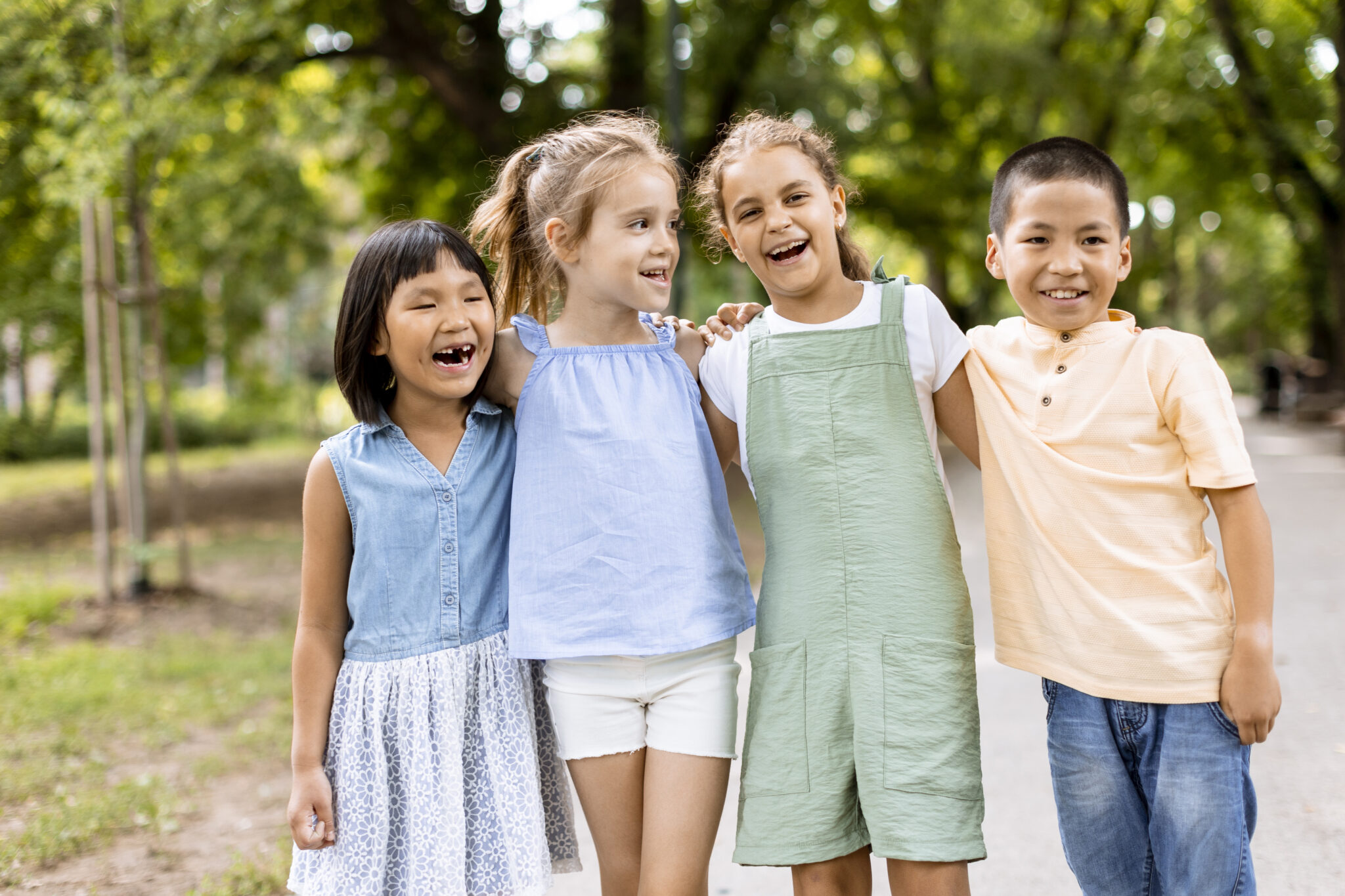 a group of children standing next to each other in a park