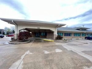 a blue and green sign that says new location immediate enrollment