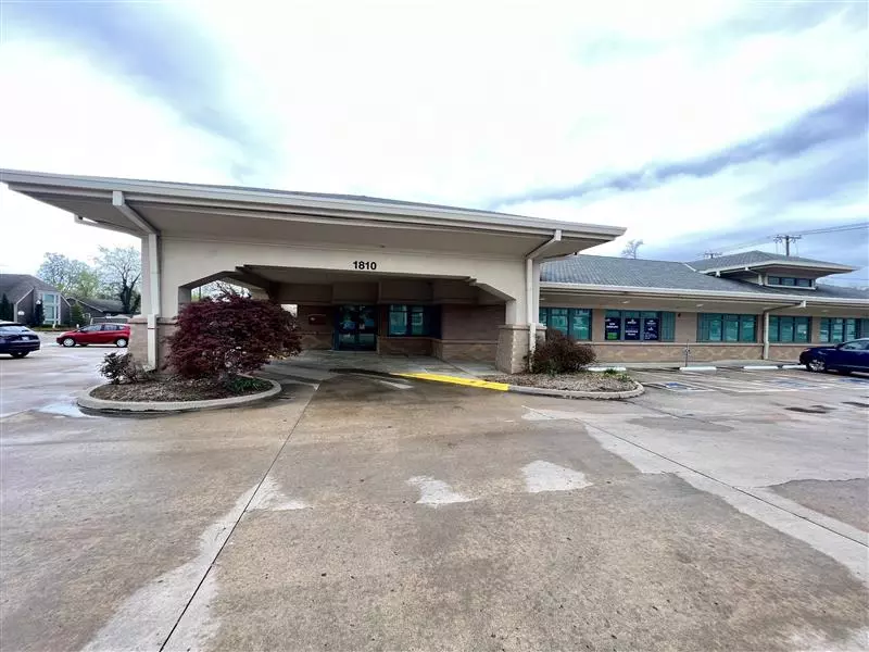a blue and green sign that says new location immediate enrollment